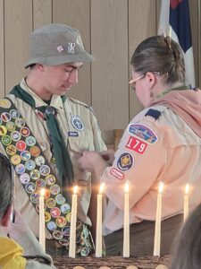 Jenelle Henry pins the Eagle Scout medal on her son William